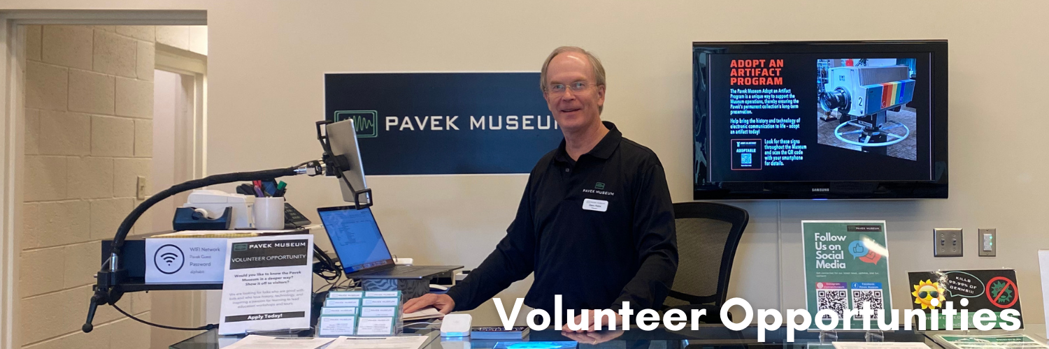 volunteer standing at welcome desk